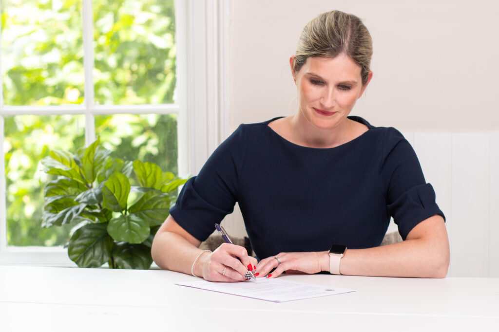 Claire Grylls, Notary Public in Kent - Signing paperwork